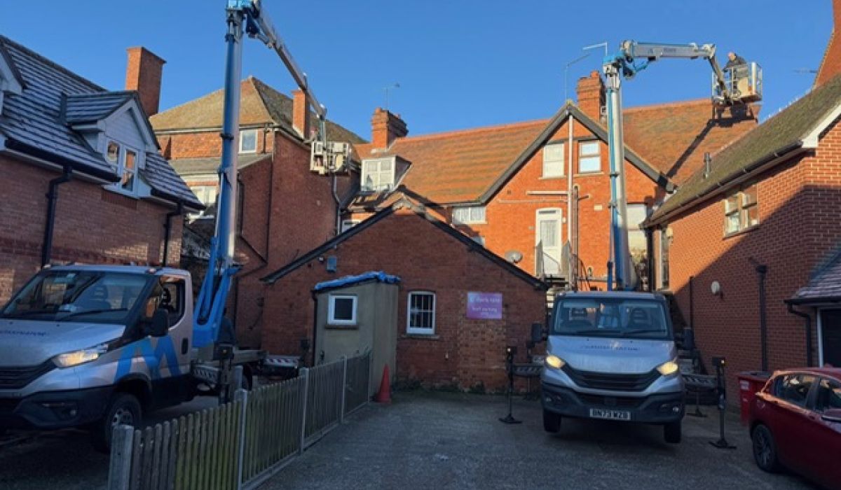 Two trucks parked in front of a residential house, showcasing a suburban setting.