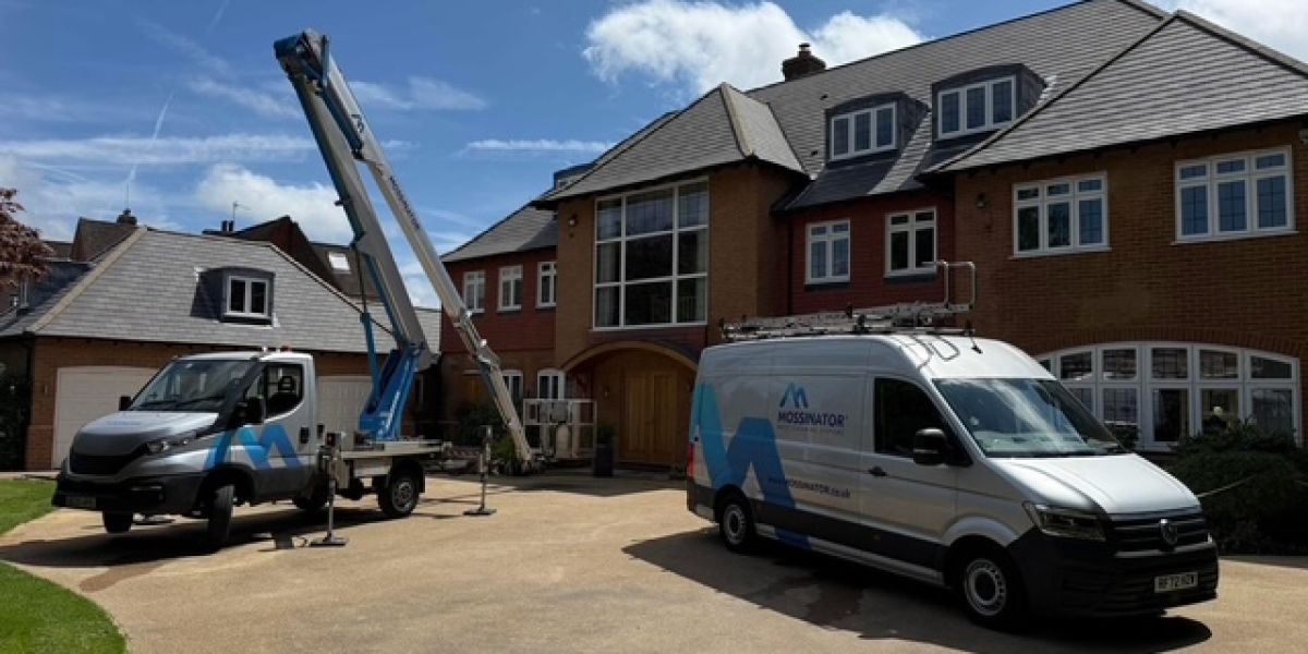 Mossinator roof cleaning vans outside a residential property in Beaconsfield, with specialist access equipment set up on the driveway.