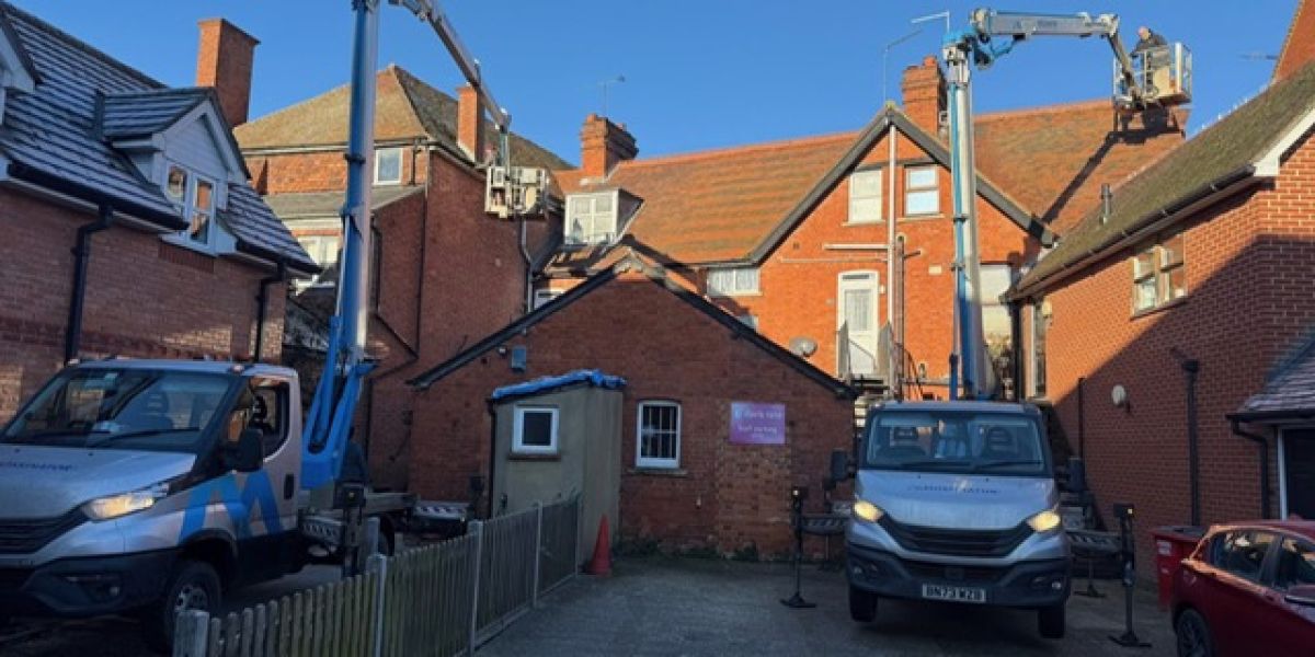 Two trucks parked in front of a residential house, showcasing a suburban setting.